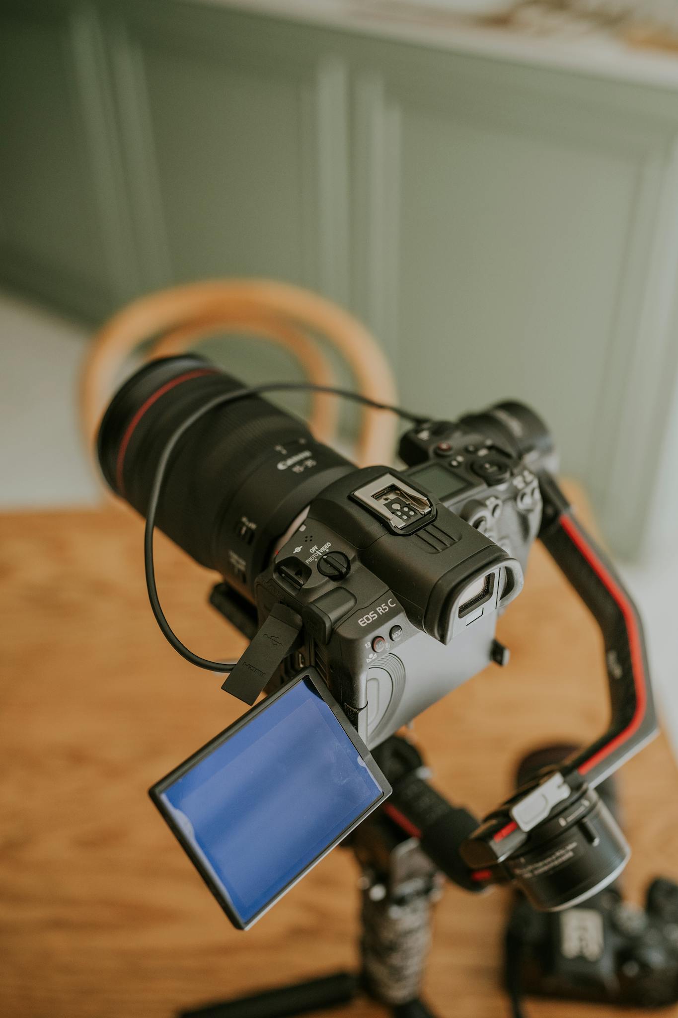 A camera on a tripod with a monitor on it